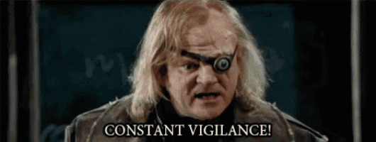 a close up of a man with a robotic eye and the words `` constant vigilance '' .