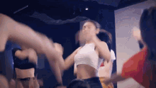 a group of young women are dancing together in a room .