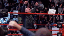 a wrestling ring with a sign that says welcome back to pw