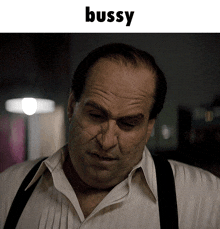 a close up of a man 's face with the word bussy above it