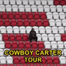 a man is sitting in a row of red and white seats with the words cowboy carter tour written above him