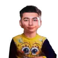 a young boy wearing a yellow spongebob shirt looks at the camera