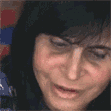 a close up of a woman 's face with her mouth open .
