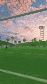 a soccer game is being played in a stadium with a sunset in the background