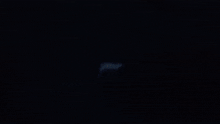a close up of a person lighting a lighter in the dark