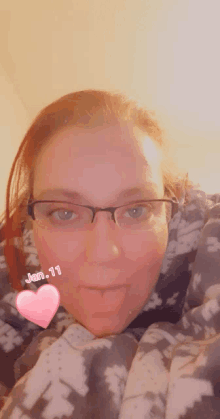 a woman wearing glasses and a blanket with the date january 11 on it