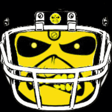 a yellow skull is wearing a football helmet on a black background