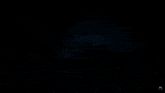 a painting of a mountain with a glowing ball in the sky