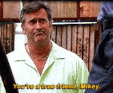 a man in a green shirt says " you 're a true friend "
