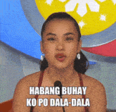 a woman speaking into a microphone with the words " habang buhay ko po dala-dala " written below her