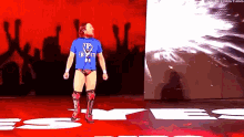 a man in a blue shirt with the letter b on it
