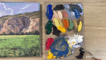 a painting on a canvas next to a palette with the words made in animatica