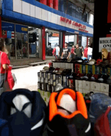 a group of people standing outside of a store that says napa complex