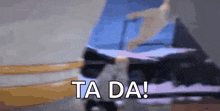 a blurry picture of a person riding a skateboard with the words `` ta da '' written on the bottom .