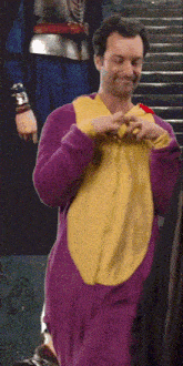 a man wearing a purple and yellow costume