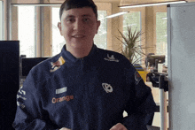 a man wearing a blue jacket that says orange on the front