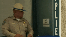 a police officer is standing in front of a door that says not an entrance