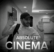 a black and white photo of a man waving with the words absolute cinema below him