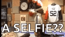 a man is taking a selfie in front of a clock and a jersey with the number 52 on it .
