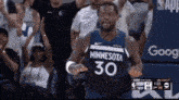 a man in a minnesota 30 jersey stands in front of the crowd