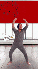 a man is dancing in front of a sign that says please do his dance