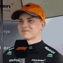 a man wearing a mclaren hat and a black shirt