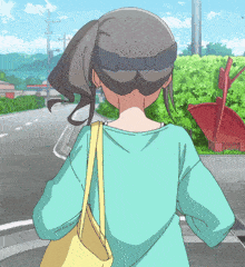 a girl with a ponytail is walking down the street