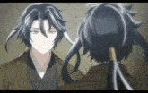 a man with long black hair looks at another man with long black hair