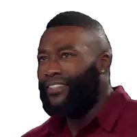 a man with a beard wearing a maroon shirt