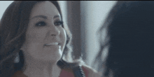 a woman is smiling while looking at another woman