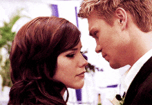 a man and a woman are looking at each other with their eyes closed