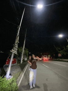 a person standing on the side of a road with a sign that says vote up