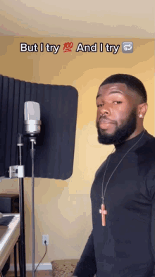 a man standing in front of a microphone with the words but i try 100 and i try