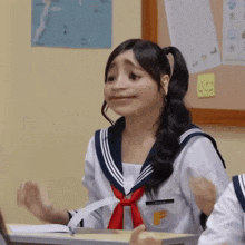 a girl wearing a sailor uniform with the letter f on it