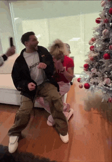 a man wearing an avalanche jacket is dancing with a girl