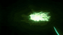a glowing blue light is coming out of a hole in the dark