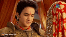 a man in armor is looking at a woman in a red dress on sony tv