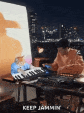 a man is playing a keyboard with a cat sitting on the keyboard