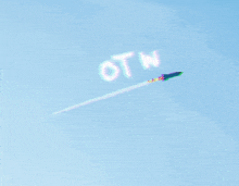 a jet flying through a blue sky with the word otn written on the clouds