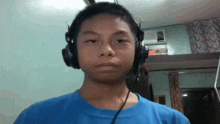 a boy wearing headphones and a blue shirt