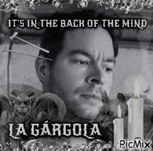 a black and white photo of a man with gargoyles and candles and the words it 's in the back of the mind