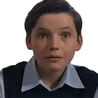 a young boy in a blue shirt and black vest looks surprised