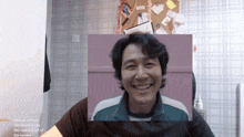 a man is smiling in front of a wall with a sticky note on it that says " hundred of injury care beside it "