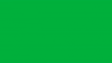 a man in a suit is running against a green screen