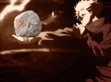 a person holding a rock in their hand with a glowing light behind them