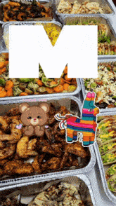 several trays of food with the letter m in the background