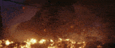 a large pile of rocks is burning in a dark room