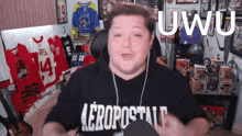 a man wearing a black aeropostale shirt is giving a speech