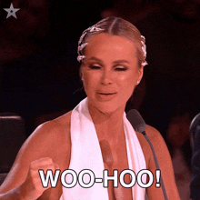 a woman sitting in front of a microphone with the words woo-hoo on her face