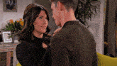 a man and a woman are looking into each others eyes